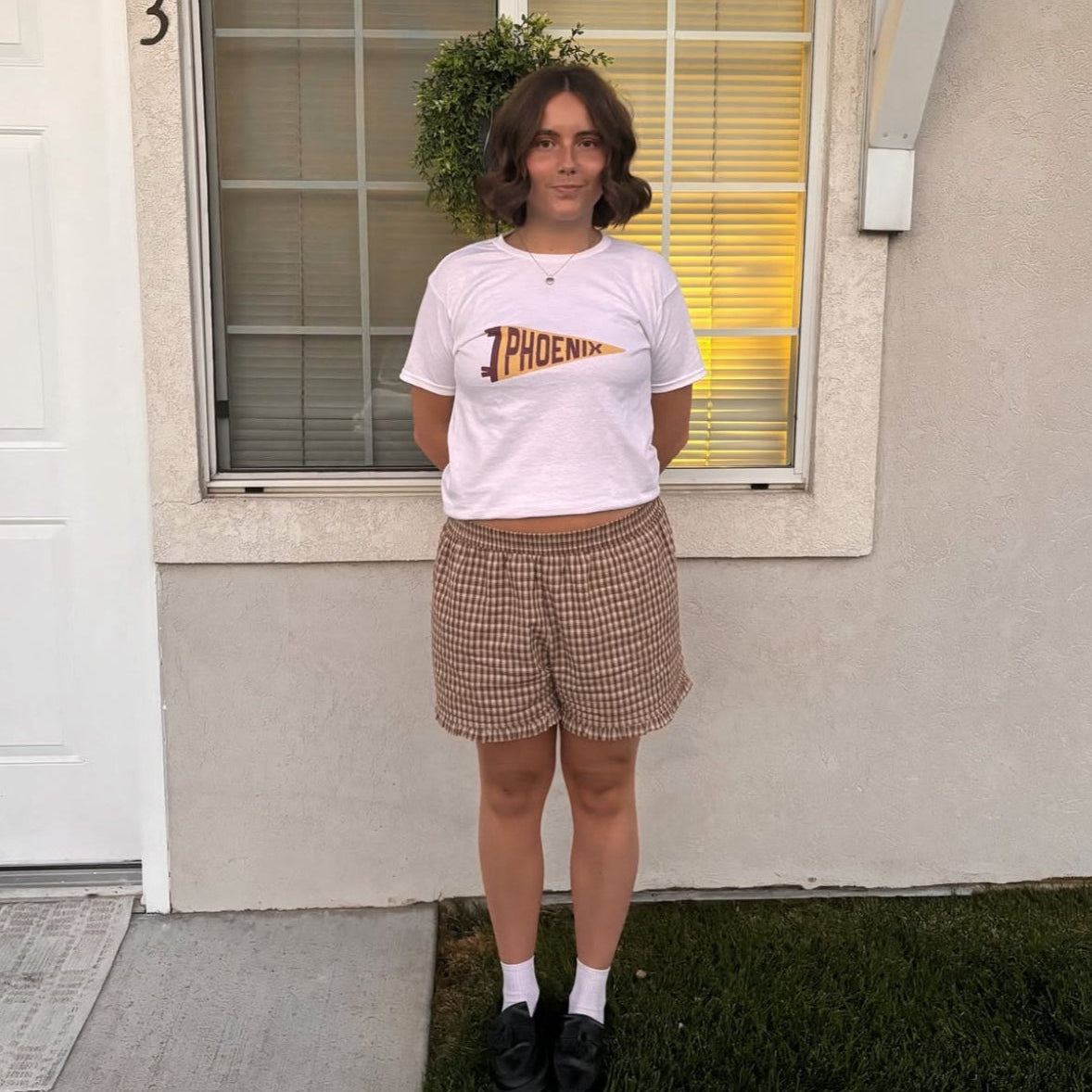 White baby tee with yellow and red Phoenix pennant graphic – Y2K-inspired crop top for women, retro college-style cotton shirt for everyday wear by Gracey Jeans